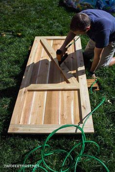 a man is working on a wooden board