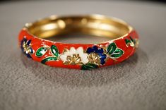 I  am offering you this antique vintage yellow gold tone eternity design bangle bracelet. This features a domed etched scrolled raised relief  multi colored enameled design to it ! It measures app. 2.5 inch inches in diameter. It measures app. 1/2 inch wide. This came out of an estate here in upstate New York where I uncovered several very older but fashion forward pieces of collectible jewelry , this gorgeous bracelet is no exception. Please review all of my pictures, as they are all a very imp Vintage Multicolor Enamel Bangle, Vintage Round Enamel Bangle, Vintage Enamel Bangle As A Gift, Vintage Enamel Bangle As Gift, Vintage Enamel Bangle For Gift, Vintage Enamel Bangle Gift, Vintage Bangle Bracelets, Vintage Bangles, Upstate New York