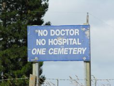 a blue sign that says no doctor, no hospital one cemetery