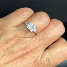 a woman's hand with a diamond ring on it