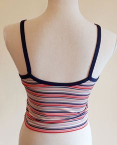 Sweet vintage Champion sports crop top. Colorful stripes,blue suspenders and a edge around the sleeve. It has a logo printed at the end. Fabric is stretchy. It is padded on the chest,see last image. In excellent vintage condition. Tag size: US M,but smaller,best fits to size US XS/S,check the measures. Materials: polyester 88%,spandex 12% Label: Champion  Measures taken flat,one side bust 36.5 - 48 cm = 14,37 - 18,90" waist 34 - 37 cm = 13,38 - 14,57" length with suspenders about 43 cm = 16,93" We will take returns only if there is a problem with condition we did not detected. Please,check the measures before purchasing. All items are vintage in excellent condition with respect to the years. Please write me a message when the package arrives and are you satisfied. Thank you for purchasing Sporty Cropped Tops With Adjustable Straps, Fitted Striped Tops For Sports, Summer Sports Tops With Contrast Stripes, Summer Workout Crop Top, Spring Striped Sports Tops, Sporty Fitted Top With Straps, Fitted Top With Contrast Stripes For Summer, Summer Sports Top With Contrast Stripes, Multicolor Fitted Tops With Adjustable Straps