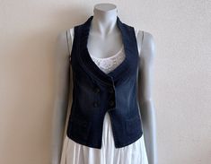 Women's Vest Blue Denim Vest Blue Jean Waistcoat Fitted Womens Sleeveless Denim Jacket  Measurements (lying flat): Length(back): 19.5"/ 49.5 cm Pit to pit: 15 3/4"/ 40 cm Waist: 15 1/4"/ 39 cm Please check measurements to insure a proper fit. Remember to allow yourself some extra room for movement. You can compare these with something from your closet that fits you well. Please convo me if you need additional measurements. Condition: Great Vintage Condition N.B. Color may slightly differ from pi Stretch Denim Blue Vest For Spring, Sleeveless Denim Jacket For Summer Workwear, Spring Stretch Denim Blue Denim Vest, Spring Stretch Denim Vest, Dark Wash Denim Vest For Workwear, Spring, Dark Wash Denim Vest For Workwear In Spring, Stretch Denim Blue Sleeveless Vest, Denim Sleeveless Vest For Work, Denim Blue Sleeveless Workwear Vest