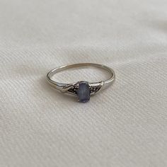 a silver ring with a blue stone on it