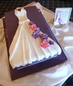 a wedding dress shaped cake sitting on top of a table