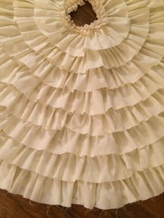 a white ruffled skirt on top of a wooden floor