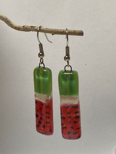 Long ‘Watermelon’ earrings Made of recycled glass that is cut, painted and fired in a kiln to fuse. The glass bead is about 1.5 inches long, and approx 0.35 inches wide. The earring from the hook to the bottom of the glass is approx 2.1 inches long Sterling 925 Silver Fish hook Wires. Please like my Facebook page www.facebook/recycledglassjewelry **All the pieces are handmade and fused in small batches. Please allow slight variations. bubbles may vary. Watermelon Earrings, Fused Glass Necklace, Small Drop Earrings, Fused Glass Earrings, Glass Drop Earrings, Silver Fish, Fused Glass Jewelry, Wine Charms, Dangling Earrings