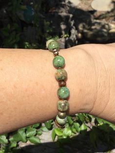 Natural  rainforest jasper in different shades of green make a unique interesting bracelet. This bracelet fits a seven inch wrist but can be altered. Beads are 8 mm and each one is unique! It has some really interesting spacer beads to add a fancy touch. Cheap Green Braided Bracelets For Festivals, Cheap Green Hypoallergenic Bracelets, Cheap Green Braided Bracelets For Women, Earthy Bracelets Aesthetic, Casual Green Beaded Bracelets With Natural Stones, Green Bohemian Stretch Bracelet With 8mm Beads, Bohemian Green Stretch Bracelet With 8mm Beads, Everyday Green Jade Beaded Bracelets, Earthy Green Jewelry With 8mm Beads