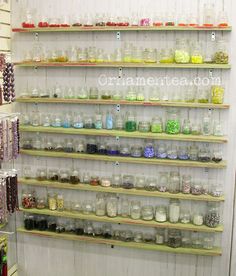 the shelves are filled with many different jars