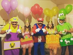 some people are dressed up as mario and luigi in costume for a party with balloons