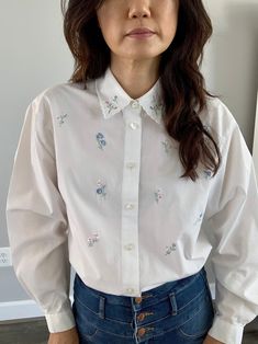 "vintage floral embroidered shirt lovely pastel tone White button down Long sleeves Scalloped collar tag: Napa valley fabric: cotton polyester blend size:Small measurements: shoulder to shoulder 18\" armpit to armpit:21.5\" arm length:22\" total length:27\" condition: good, has some faint spots near sleeve and front bottom" Embroidered Shirt With Collared Neckline For Spring, Feminine Spring Shirt With Spread Collar, Feminine Spread Collar Shirt For Spring, Collared Floral Embroidery Top For Work, Feminine Collared Blouse With Floral Embroidery, Collared Top With Floral Embroidery For Work, Floral Embroidery Collared Blouse For Work, Spring Shirt With Embroidered Spread Collar, Spring Embroidered Shirt With Spread Collar