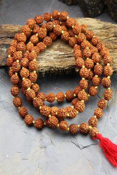 This simple hand-crafted mala featuring a deep red tassel, is made of 108 knotted Rudraksha seed beads and is perfect for your everyday ritual and mediation. Legend has it that the first Rudraksha seeds were created from tears of Lord Shiva as they fell on the earth and formed into a tree. Rudraksha seeds have wonderful spiritual and medicinal properties and, you can feel their power as you count through the beads one by one to recite your chosen mantra or intention. The number 108 holds spiritu Tibetan Yak, Rare Beads, Rudraksha Mala, Powerful Prayers, Mala Meditation, 108 Bead, Bone Beads, Beads Handmade, Power Of Prayer