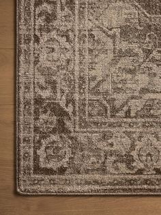 a brown and white rug on top of a wooden floor