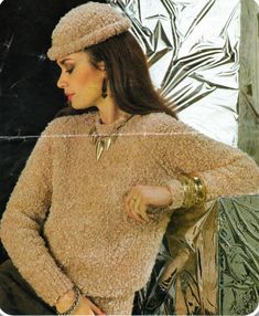 a woman wearing a brown sweater and hat