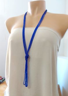 "This is a beautiful sparkly blue color beaded long necklace that measures about 44 inches long in total . The knot is adjustable, simple to undo and redo at the height you would like! Or you can wear the necklace double up without any knot! It is a very versatile necklace that can be adapted to your taste. ❤ PROCESSING AND SHIPPING Most orders are made and shipped out in one business day. Please check delivery timeframes for your location on the description below. ❤ CUSTOM ORDERS If you like th Adjustable Blue Lariat Necklace, Blue Adjustable Lariat Necklace, Blue Lariat Jewelry For Party, Blue Handmade Adjustable Lariat Necklace, Handmade Adjustable Blue Lariat Necklace, Adjustable Handmade Blue Lariat Necklace, Elegant Beaded Tassel Necklace For Beach, Elegant Long Necklace Beads For Beach, Beaded Multi-strand Lariat Necklace As Gift