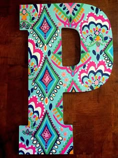 the letter p is made up of colorful fabric and has an ornate pattern on it