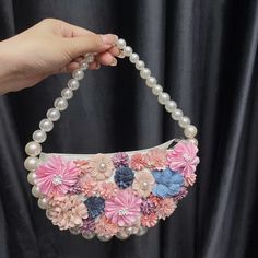 Delicate blossoms, each finely inlaid and framed by glossy pearls, adorn this captivating dumpling-shaped clutch, making it a striking and eye-catching piece. The Flora Diamond Handbag’s stylish pearl handle gives its already exquisite design even more refinement. Carrying all your essentials in elegance is made easy with this lightweight and stylish bag. Floral Heels, Bangle Ring, Bridal Belt, Bridal Bracelet, Bridal Tiara, Simple Bags, Bridal Jewelry Sets, Bridal Necklace, Love Ring