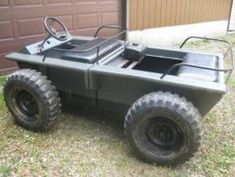 an off road vehicle is parked in front of a garage