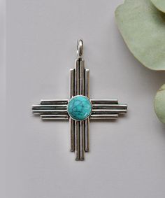 Turquoise Zia Pendant / Handmade Zia Symbol Pendant / Zia Statement Jewelry / New Mexico Zia Necklace / Zia Sun Pendant For Native Americans items : Pendant & Necklace Stone : Turquoise Shape : Zia Symbol Cut : cabochon  Material : 925 Sterling Silver Measurement : 2''x 2'' (inch) Zia Symbol : The Zia symbol consists of a circle with four groups of rays radiating from the center, forming a sun-like image. Each group typically has four rays, representing various aspects of life, such as the four Bohemian Turquoise Cross Necklace, Blue Bohemian Necklace With Cross Pendant, Bohemian Blue Cross Pendant Necklace, Bohemian Turquoise Cross Jewelry, Bohemian Blue Cross Jewelry, Bohemian Turquoise Cross Pendant Jewelry, Bohemian Turquoise Cross Pendant Necklace, Handmade Turquoise Cross Pendant Necklace, Handmade Turquoise Cross Jewelry