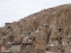 an old village built into the side of a cliff face with no people on it