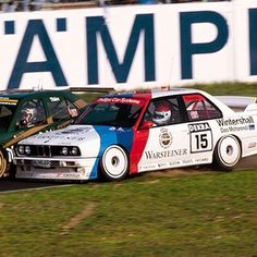 two racing cars on a track with the number 15mph in front of them