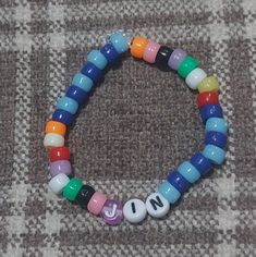 This bracelet has alot of meaning to it there names are with there favorite colors and are really cute to were to support them. Adjustable Multicolor Name Bracelet With Colorful Beads, Multicolor Name Bracelet With 8mm Beads For Gift, Kpop Style Personalized Multicolor Bracelets, Customized Multicolor Kpop Bracelets, Playful Multicolor Letter Beads Name Bracelet, Bts Band, Bracelet Set, Beaded Bracelet, Favorite Color