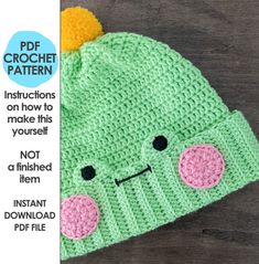 a crocheted hat with a face on it