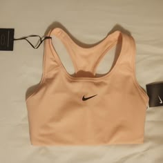 Peachy Pink In Color Pink Tops For Light Sports, Pink Tops For Spring Light Sports, Pink Spring Tops For Light Sports, Spring Pink Sports Bra, Pink Seamless Tops For Light Sports, Pink Sports Bra For Spring Workout, Pink Seamless Activewear For Light Sports, Pink Sports Bra For Light Sports With Medium Support, Pink Fitted Sports Bra For Light Sports