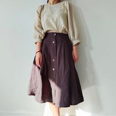 "This Button Front Linen Skirt with Pockets is a beautiful vintage-inspired piece that combines style and functionality. Made from high-quality linen fabric, this A-line skirt features a midi length, which falls just below the knee. The washed finish gives it a relaxed, casual vibe that makes it perfect for everyday wear. The skirt is designed with a button front closure, which adds a touch of elegance and sophistication to the overall look. The buttons are placed asymmetrically, creating an int How To Wear Midi Skirt, Skirt With Button Up Shirt, Button Down Shirt With Skirt, Style For Women In Their 30s, Plain Skirt Outfit, Knee Length Skirt Outfit, Vintage Cottagecore Outfits, Linen Skirt Outfit, Midi Skirt Outfits