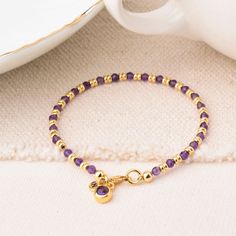 Say hello to the Amethyst Linear Bracelet, a must have for February babies or anyone taken with the beauty of amethyst! This birthstone bracelet is all about that laid back look. Each amethyst gemstone brings that gorgeous purple hue, radiating calming energy and good vibes. Its simple yet stylish design makes it a perfect match for any outfit, whether you're rocking jeans and a tee or dressing up for a night out. Available in eco Sterling Silver or Gold Plated eco Sterling Silver with natural amethyst facet beads and an amethyst charm let your wrist sparkle and shine with this beautiful February birthstone bracelet! Amethyst: emotional stability | intuition | physical health We want your jewellery to stay in great condition so you can enjoy it for years to come. With some simple steps you Spiritual Amethyst Beaded Birthstone Bracelet, Amethyst Beaded Bracelet With Birthstone As Gift, Amethyst Birthstone Beaded Bracelet Gift, Purple Amethyst Birthstone Bracelet, Amethyst Bracelets In Yellow Gold For Gift, Amethyst Yellow Gold Bracelets For Gift, Amethyst Yellow Gold Bracelet For Gift, Amethyst Yellow Gold Bracelets With Gemstones, Yellow Gold Amethyst Bracelets As A Gift