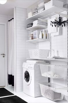 a white washer and dryer in a room with red rugs on the floor