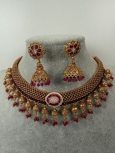 This exquisite piece of craftsmanship comes from our Traditional collection. Finish: 24 grams gold finish Necklace Fastening: Adjustable Dori  Perfect for Indian weddings. Earring jhumka Fastening: Push Back Contains: 1 necklace, 1 pair of earrings Luxury Temple Jewelry Chandbalis For Diwali, Luxury Temple Necklace For Diwali, Luxury Temple Jewelry Danglers For Celebrations, Gold Plated Round Temple Necklace For Festive Occasions, Festive Gold Plated Round Temple Necklace, Gold Chandbali Temple Jewelry Necklace, 22k Gold Chandbali Necklace As Gift, 22k Gold Chandbali Necklace For Gift, Gold Plated Chandbali Necklace For Celebrations