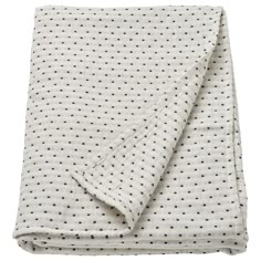 the white and black polka dot blanket is folded up