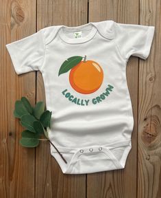 Do you have a 'locally grown' little one- or know someone who does? This bodysuit makes a great gift, baby announcement or just a cute everyday outfit! Image is a DTF transfer and will last through all the washes! Comfy enough for your little one to play in all day!  All shirts are made to order and my current turn around time is about 2 weeks until your order will ship. Please keep this in mind when ordering. Cute Orange Cotton Onesie, Fitted Onesie For Summer Gift, Spring Cotton Bodysuit For First Birthday, First Birthday Spring Cotton Bodysuit, Playful Cotton Bodysuit As A Gift, Casual Summer Onesie As Gift, Casual Cotton Bodysuit As Gift, Playful Summer Onesie For Gifts, Playful Summer Onesie For Gift