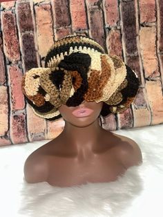 a mannequin head wearing a multicolored crocheted hat on it's head