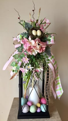 a vase filled with flowers and eggs on top of a table