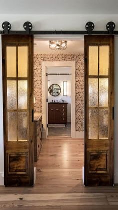 an open door leading into a bathroom with wood floors