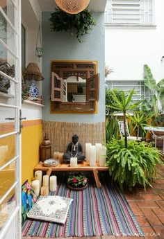 a room with a table, mirror and plants