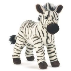 a stuffed zebra is standing in front of a white background with the word ganz on it