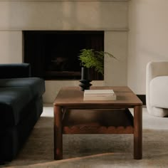 a living room with two couches and a coffee table in front of a fireplace