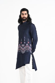 Navy Phulkari inspired Nehru Jacket with pipe, cutdaana and thread work embroidery with overlapping kurta highlighted with embroidery detail on the chest and stitchline border made in Bamberg Raw Silk. Paired with Ivory slim fit Pant Pajama. Color of the actual garment may vary due to lighting conditions during the shoot.
 

Size Chart For Men





	
	
					Men's Size Chart
		

		
		
						
				Size Chart For Men
				Custom Size Measurement Guide
			
			
				
				
				Custom Size Measurement Gui Festive Raw Silk Bandhgala With Floral Embroidery, Festive Bandhgala With Floral Embroidery In Raw Silk, Transitional Bandhgala With Floral Embroidery In Raw Silk, Designer Raw Silk Nehru Jacket With Floral Embroidery, Transitional Designer Kurta With Cutdana, Festive Raw Silk Nehru Jacket With Floral Embroidery, Traditional Raw Silk Bandhgala With Chikankari Embroidery, Festive Nehru Jacket With Floral Embroidery In Raw Silk, Bollywood Bandhgala With Floral Embroidery For Transitional Season