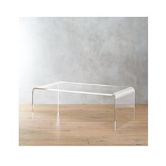 a glass table sitting on top of a hard wood floor