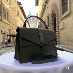 This bag has been made of the best genuine leather by local master crafters of Florence in Italy, designed for women who only accept premium Italian quality and luxury leather bags and modern Italian fashion. . Sizes: Width: 29cm/10.6 inch Height: 19cm/7.4 inch Depth: 7 cm/3.9 inch The story of this bag:  John was visiting Florence with his family and he wanted to find the perfect gift for his wife and daughters. He had heard about the exquisite leather craftsmanship in the city and was determined to find something unique and special. After wandering around the streets for a while, John stumbled upon a small leather shop. As soon as he stepped inside, he was greeted by the warm scent of leather and the sight of beautiful bags lining the shelves. One particular bag caught John's eye - a stu Luxury Olive Leather Shoulder Bag, Green Leather Flap Bag For Everyday Use, Luxury Olive Bag With Detachable Strap, Workwear Flap Bag With Textured Leather, Everyday Green Leather Flap Bag, Leather Flap Bag With Smooth Grain For Daily Use, Daily Use Leather Flap Bag With Smooth Grain, Textured Leather Flap Bag For Daily Use, Elegant Satchel Flap Bag With Leather Handles