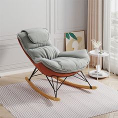 a rocking chair in a living room next to a window