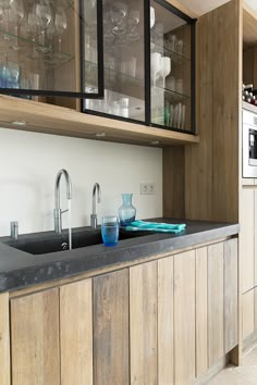 a kitchen with wooden cabinets and black counter tops