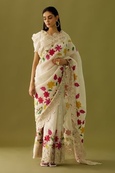 Ivory organza saree with multi colored floral embroidered appliques and cutwork hem. Comes with matching chanderi blouse  piece.
Component: 1
Pattern: Embroidered
Type Of Work: Floral Appliques
Fabric: Organza, Chanderi
Color: Ivory
Other Details: 
Cutwork detailing
Note: The blouse worn by the model is not for sale
Occasion: Destination Wedding - Aza Fashions Saree Pattern, Cutwork Saree, Alaska Fashion, Indian Outfits Lehenga, Saree Embroidery, Blouse Designs Indian, Saree Designer, Dresses Traditional, Beautiful Sarees