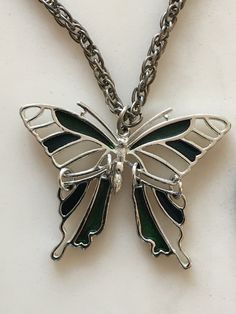 This beautiful antique butterfly pendant necklace is in excellent condition. This piece of jewelry would be a great addition to anyone's collection or as a gift. Metal Butterfly Pendant Necklace With Clavicle Chain, Silver Metal Butterfly Jewelry, Silver Butterfly Metal Jewelry, Metal Butterfly Clavicle Chain Jewelry, Butterfly Shaped Clavicle Chain Jewelry, Green Butterfly Charm Pendant Necklace, Metal Butterfly Pendant Necklace For Gift, Silver Metal Necklace With Butterfly Charm, Silver Butterfly Necklace With Butterfly Clasp