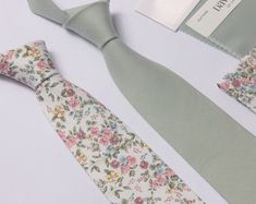 We select these  dusty sage green  fabric to match the wonderful dusty sage dress of David's bridal.... This tie/bow tie  is a Wedding Favorite ~it  is perfect for weddings or special occasions. Fabric: linen / cotton floral  Fabric Care: Dry-clean Only The default  ribbon of bow tie is white ribbon and the default color of suspenders is brown . If you want other colors, please remark in the note when you place order.   Return Policy: If you are unhappy with your item, be it damage, defect or ot Green Standard Tie For Wedding, Green Suit And Tie Accessories For Spring Wedding, Green Tie For Spring Gift, Green Wedding Suit And Tie Accessories For Spring, Green Bow Tie For Wedding, Green Bow Tie For Weddings, Green Summer Ties For Groom, Green Summer Wedding Tie, Pink Sage Wedding