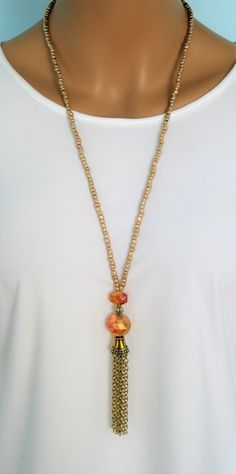 Crystal and Gold Beaded Necklaces with gold chain tassels, handmade by Ralston Originals. These beautiful beaded necklaces come in your choice of 3 different Styles. I made all the tassels with gold metal chains, and covered them with a beautiful antique gold metal bead cap. The first necklace (pictures 1-3) is made with a large round sparkling golden crystal bead, a rectangle shaped golden crystal bead, and a gold metal bead in between the two crystals. The beaded chain is made with gold seed b Gold Metal Beaded Necklace With Dangling Beads, Gold Beaded Necklace With Dangling Metal Beads, Gold Bohemian Beaded Necklace With Dangling Beads, Gold Necklaces With Dangling Metal Beads, Bohemian Gold Beaded Necklace With Dangling Beads, Gold Czech Glass Bohemian Necklace, Gold Bohemian Czech Glass Necklace, Dangle Beaded Necklaces With Gold Beads For Jewelry Making, Dangle Gold Beaded Necklaces For Jewelry Making