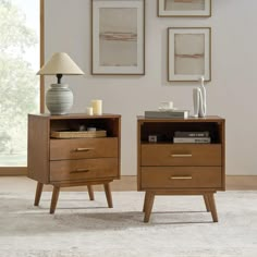 two nightstands side by side with books and magazines on them in a living room