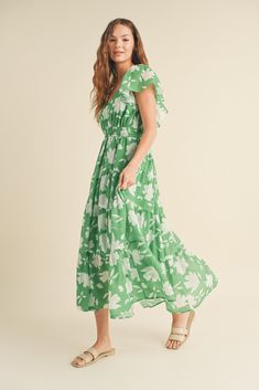 FINAL SALE this green and white floral dress from wishlist is giving me vacay vibes! perfect for a night out, sipping your favorite bev. it's also a lovely dress for a summer wedding or a bridal shower. a maxi dress with flutter sleeves, an elegant neckline, smocking at the waist and back, with a tiered skirt. it's lined and has pockets. you will look timeless in this dress. pair with some subtle jewelry and accessories and the perfect sandals to complete the look! our model is wearing a size sm Spring Green Floral Print Maxi Dress, Green Floral Maxi Dress For Summer, Green Floral Print Maxi Dress For Spring, Green Summer Floral Maxi Dress, Breezy Floral Print Maxi Dress, Green Floral Maxi Summer Dress, Spring Breezy Maxi Dress With Floral Print, Green Breezy Midi Dress For Beach, Breezy Floral Print Maxi Dress For Garden Party